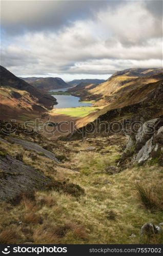 Epic Autumn Fall landscape of Buttermere and Crummock Water surrounded by mountain peaks in Lake District