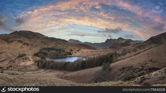 Epic drone landscape image of Blea Tarn in Lake District during Autumn Fall sunrise