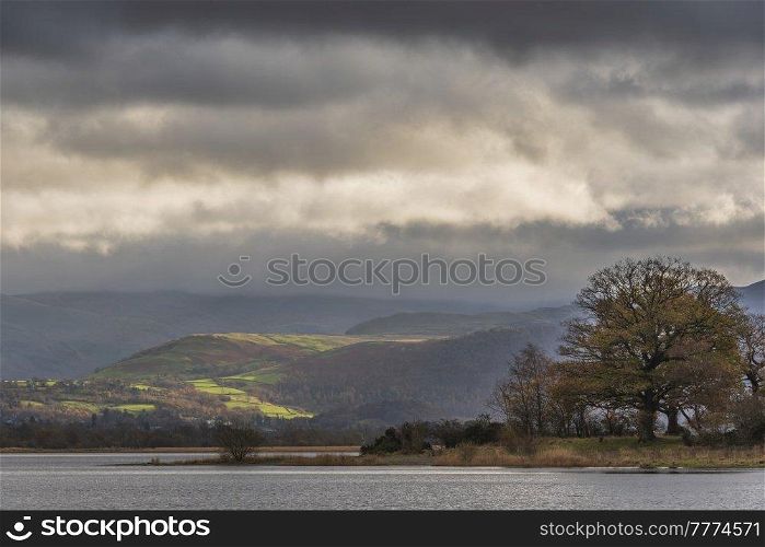 Epic landscape image across Bassenthwaite Lake in Lake District suring dramatic Autumn evening