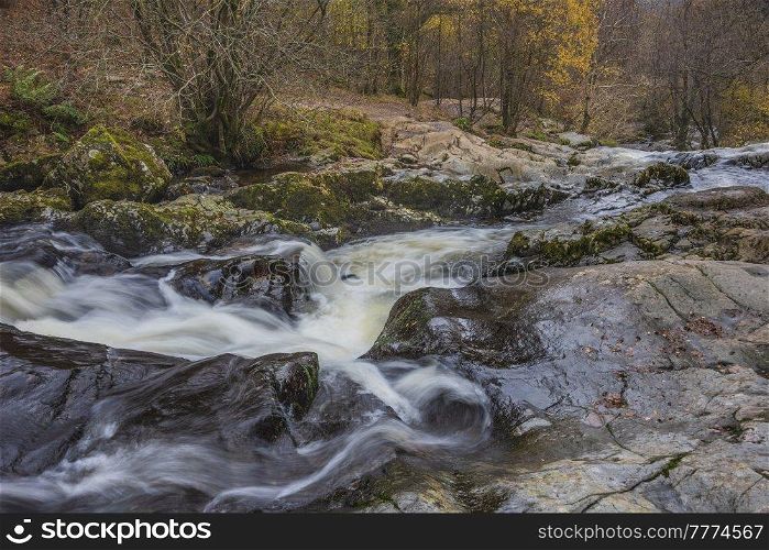 Epic landscape image of Aira Force Upper Falls in Lake District during colorful Autumn showing