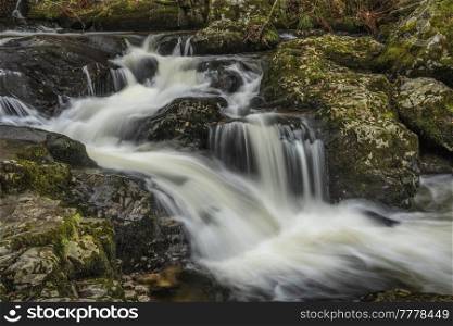 Epic landscape image of Aira Force Upper Falls in Lake District during colorful Autumn showing