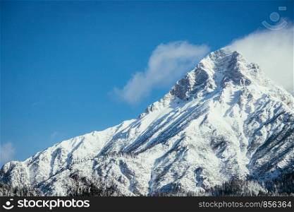 Epic snowy mountain peak with clouds in winter, landscape, alps, austria