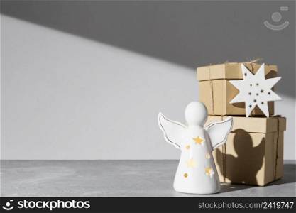 epiphany day angel figurine with gift boxes copy space