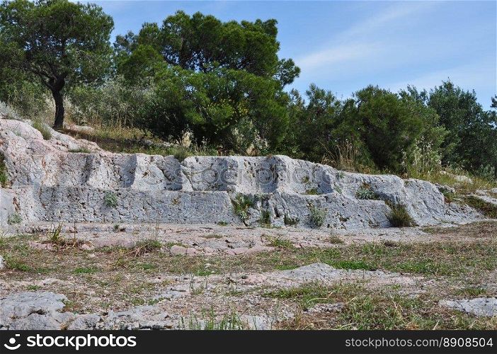 Eptathronon seven thrones plateau ancient greek ruins on philopappos hill. Rock hewn seats remains of a public square or assembly court.
