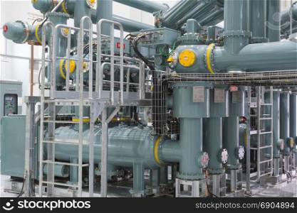 Equipment, cables and piping as found inside of industrial power plant