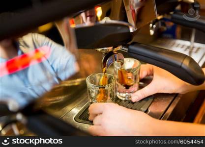equipment, coffee shop, people and technology concept - close up of woman making coffee by espresso machine at cafe bar or restaurant kitchen