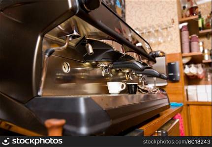 equipment, object and technology concept - close up of coffee machine at cafe bar or restaurant kitchen