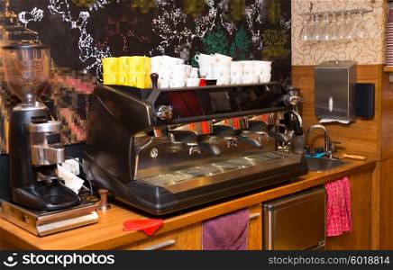 equipment, object and technology concept - close up of coffee machine at cafe bar or restaurant kitchen