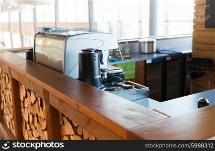 equipment, object and technology concept - close up of coffee machine at bar or restaurant counter