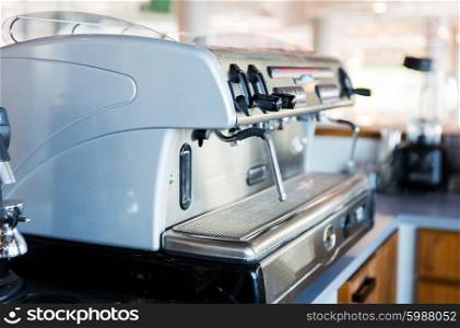 equipment, object and technology concept - close up of coffee machine at bar or restaurant kitchen