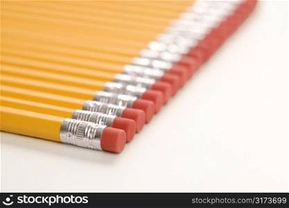 Eraser ends of group of pencils lined up in an even row.