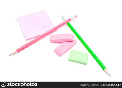 erasers, pencils and sticky note on white