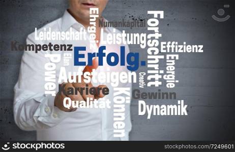 Erfolg (in german Success) Wordcloud touchscreen is operated by man.. Erfolg (in german Success) Wordcloud touchscreen is operated by man