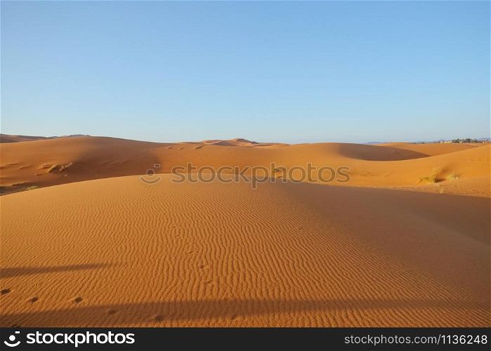 Erg Chebbi sand dunes against clear blue sky background in Sahara desert. Merzouga, Morocco.