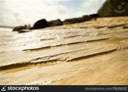 erosion of the tide on a sandy beach with shallow d.o.f