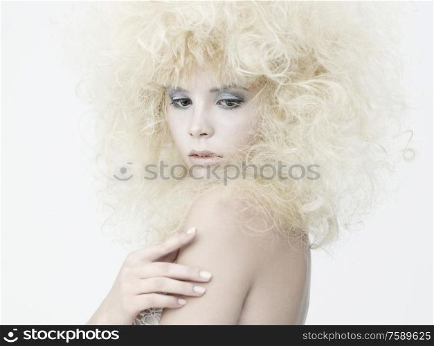 Erotic portrait of young beautiful woman. Sexy blonde with fashionable makeup. Lady with stylish hairstyle. Studio photography of pretty model.