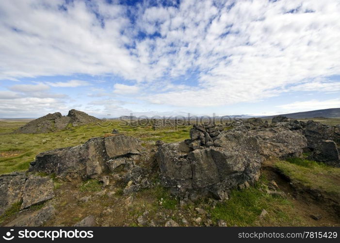 Erratic lava formations across the tundra over the volcanic mountain range the Kerlingafjoll in Hveravellir; an area on the atlantic ridge, separating the Eurasian plate form the North American plate