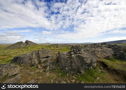Erratic lava formations across the tundra over the volcanic mountain range the Kerlingafjoll in Hveravellir; an area on the atlantic ridge, separating the Eurasian plate form the North American plate