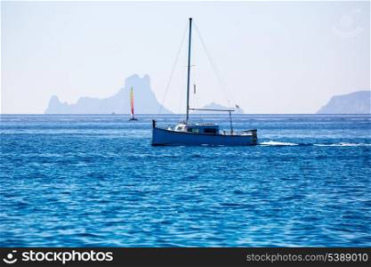 Es Vedra Ibiza silhouette with boats view from Formentera in Balearic islands