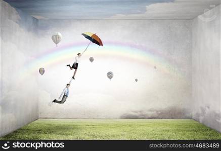 Escape from office. Businessman and businesswoman flying on colorful umbrella