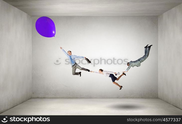 Escape from office. Businesspeople holding each other and flying on colorful balloon