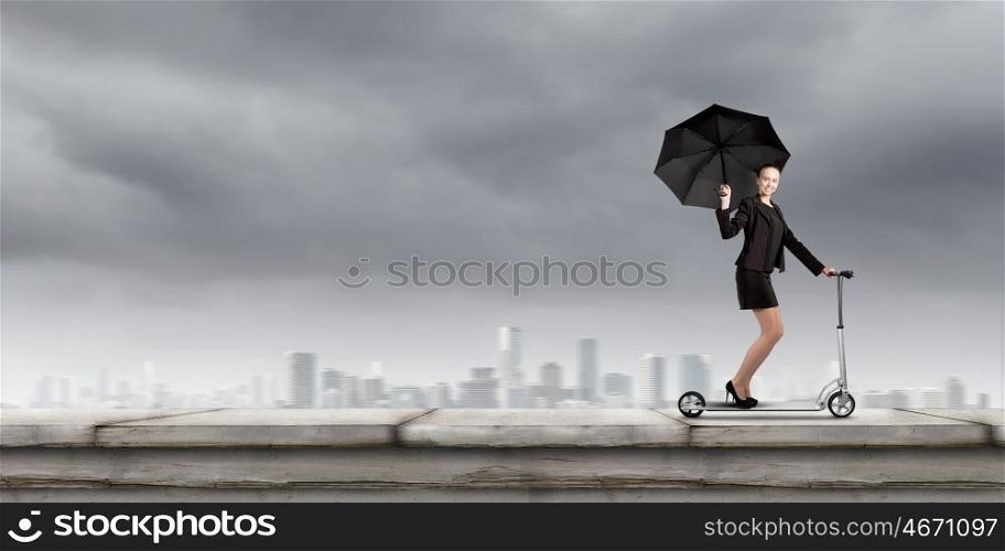 Escape from office. Young cheerful businesswoman riding scooter against city background