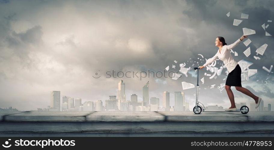 Escape from office. Young cheerful businesswoman riding scooter against city background