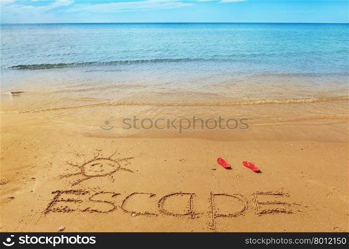 Escape message on the beach sand - vacation and travel concept