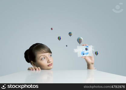 Escaping from reality. Conceptual image of woman looking in opened door