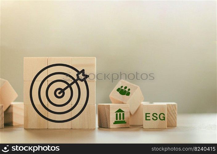 ESG Concepts on Environment, Society and Governance along with sustainable development of the organization Target symbol and ESG icon on wooden block background. copy space