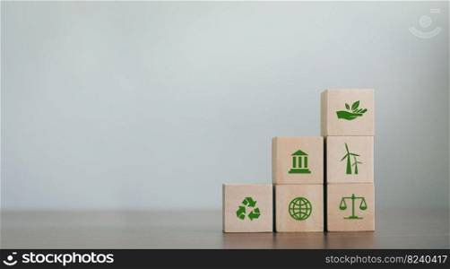 ESG Concepts on Environment, Society and Governance Revolving Sustainable Organization Development Wooden block with environmental ESG icon on gray background. copy space