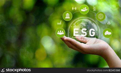 ESG icon concept in hand for environmental, social and governance in sustainable, renewable resources and networking icons on green background.