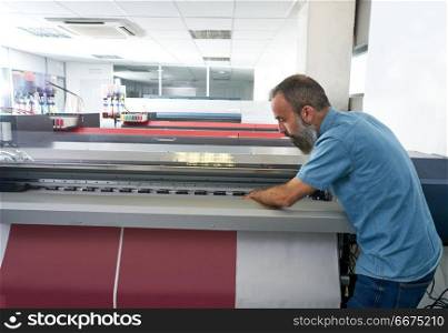 Espertise man in transfer printing industry plotter. Espertise man in transfer printing industry plotter printer hipster beard