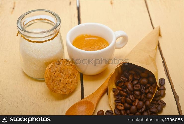 espresso coffee and beans on a paper cone cornucopia over white background
