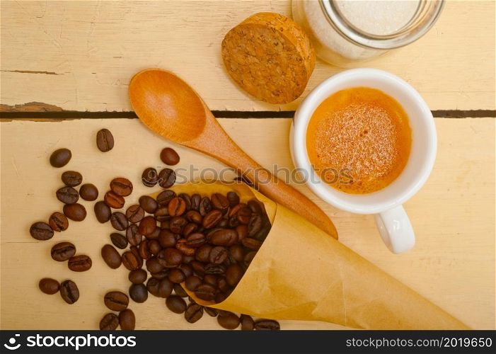 espresso coffee and beans on a paper cone cornucopia over white background
