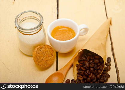 espresso coffee and beans on a paper cone cornucopia over white background