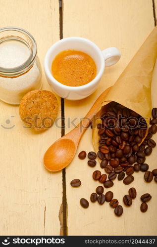 espresso coffee and beans on a paper cone cornucopia over white background