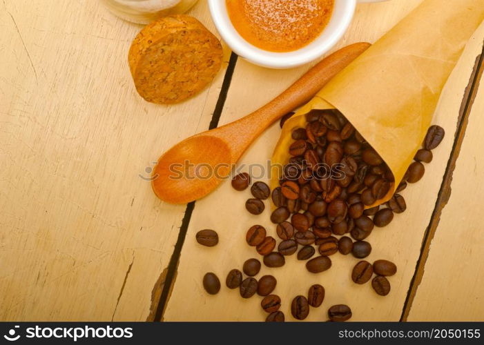 espresso coffee and beans on a paper cone cornucopia over white background