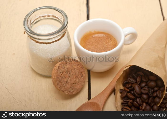 espresso coffee and beans on a paper cone cornucopia over white background