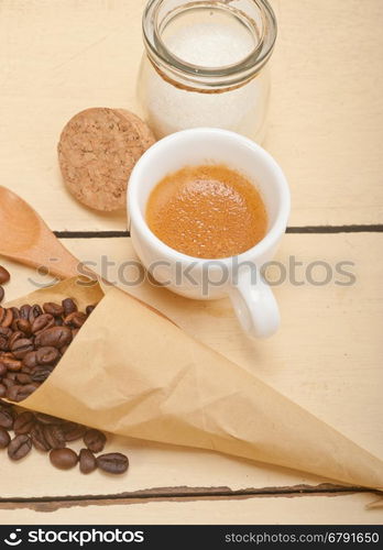 espresso coffee and beans on a paper cone cornucopia over white background