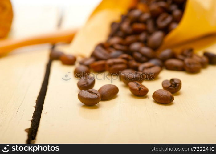 espresso coffee beans on a paper cone cornucopia over white background