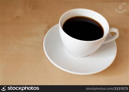 Espresso coffee in white mug on wooden table