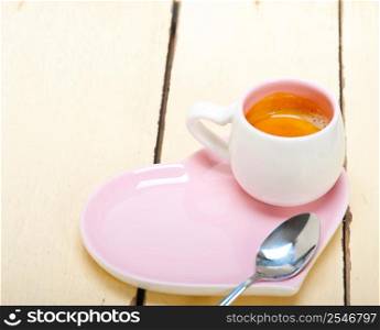 espresso coffee served on a pink heart shaped dish