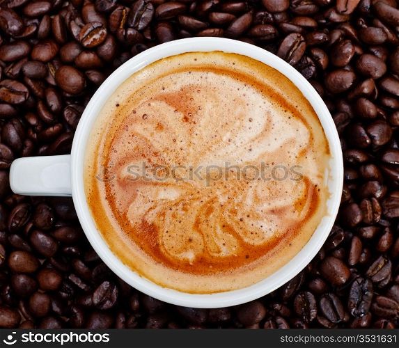 espresso cup in coffee beans, front view