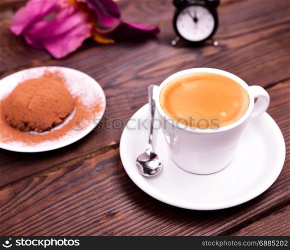 espresso in a white cup with saucer and chocolate cake