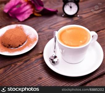 espresso in a white cup with saucer and chocolate cake