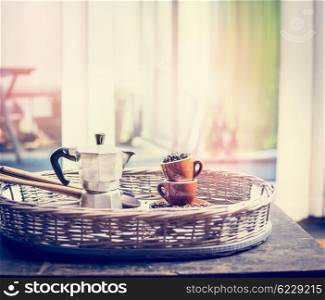 Espresso set with coffee cups, beans and coffee pot on sweet coffee on window sill background