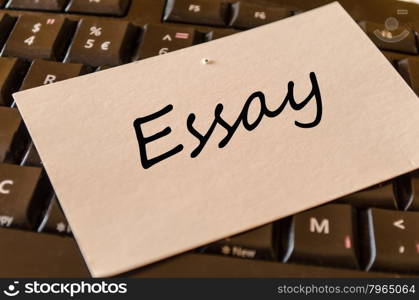 Essay text concept note on dark keyboard background