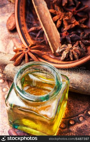 Essential cinnamon oil in bottle. Essential oil with cinnamon and anise in bottle