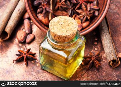 Essential cinnamon oil in bottle. Essential oil with cinnamon and anise in bottle